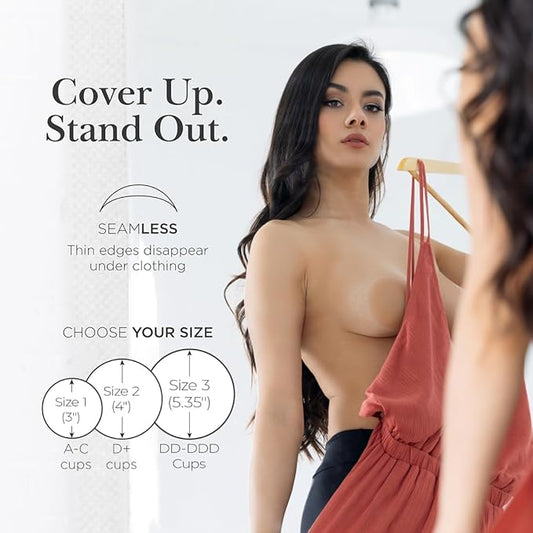 Woman wearing nipple covers with seamless edges holding a red dress, sizing guide included