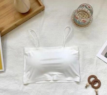 White comfortable lingerie pack camisole top with thin straps on a soft fabric background