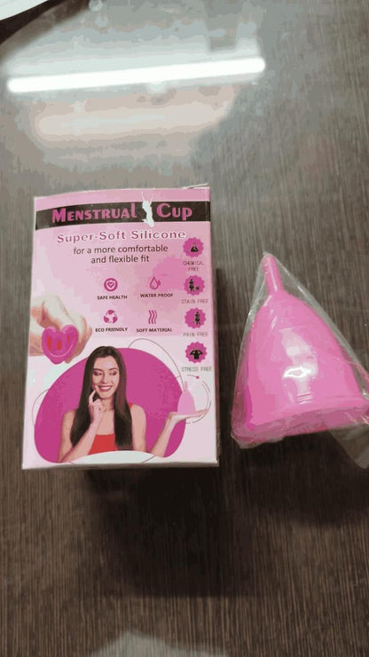 Pink menstrual cup made of super soft silicone next to its pink and white packaging box