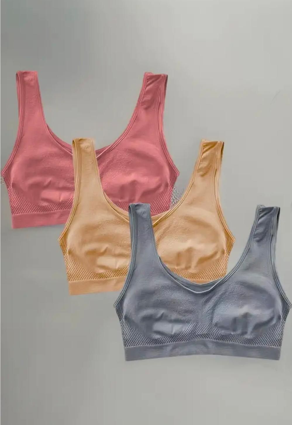 Set of three stylish breathable bras in pink beige and gray with seamless design for comfort